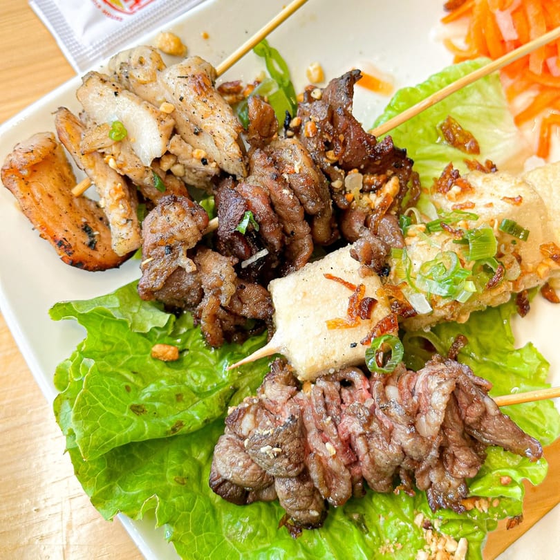 Vietvana Pho Noodle House's grilled meat and tofu skewers on lettuce with pickled carrots.